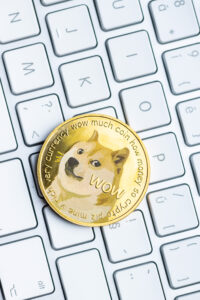 Golden dogecoin coin. Cryptocurrency dogecoin. Doge cryptocurrency and computer keyboard.