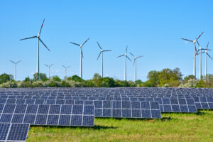 solar panels with windmills in the distance