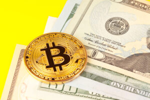 golden bitcoin coin and us dollars image