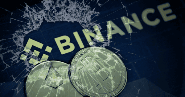 A cracked glass overlays the Binance logo with Ethereum and Bitcoin coins in the foreground, suggesting trouble or crisis for the cryptocurrency exchange.