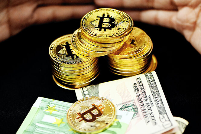 Bitcoin and dollar bills