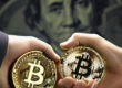 Two Bitcoin tokens in hand