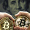 Two Bitcoin tokens in hand