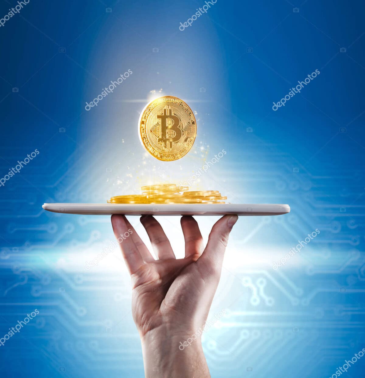 A hand holds a tablet with several golden Bitcoin coins stacked on top, one coin floating above the device, with a glowing blue digital background.