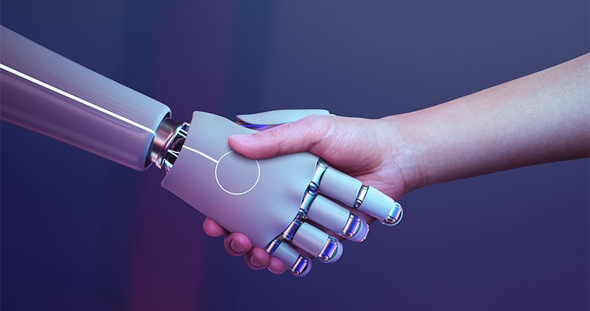 A human hand shakes hands with a robotic hand against a purple gradient background, symbolizing collaboration between humans and technology.