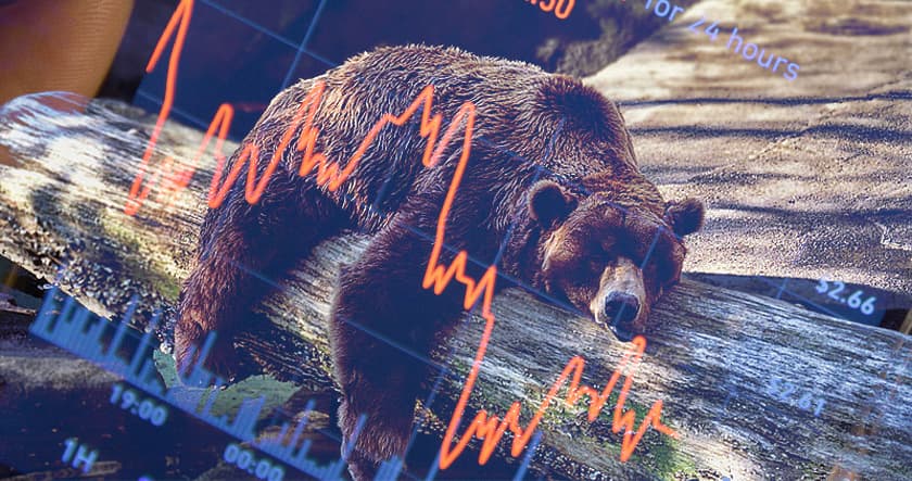 A bear lying on a log with a downward-trending stock chart graph superimposed, symbolizing a bearish stock market trend.