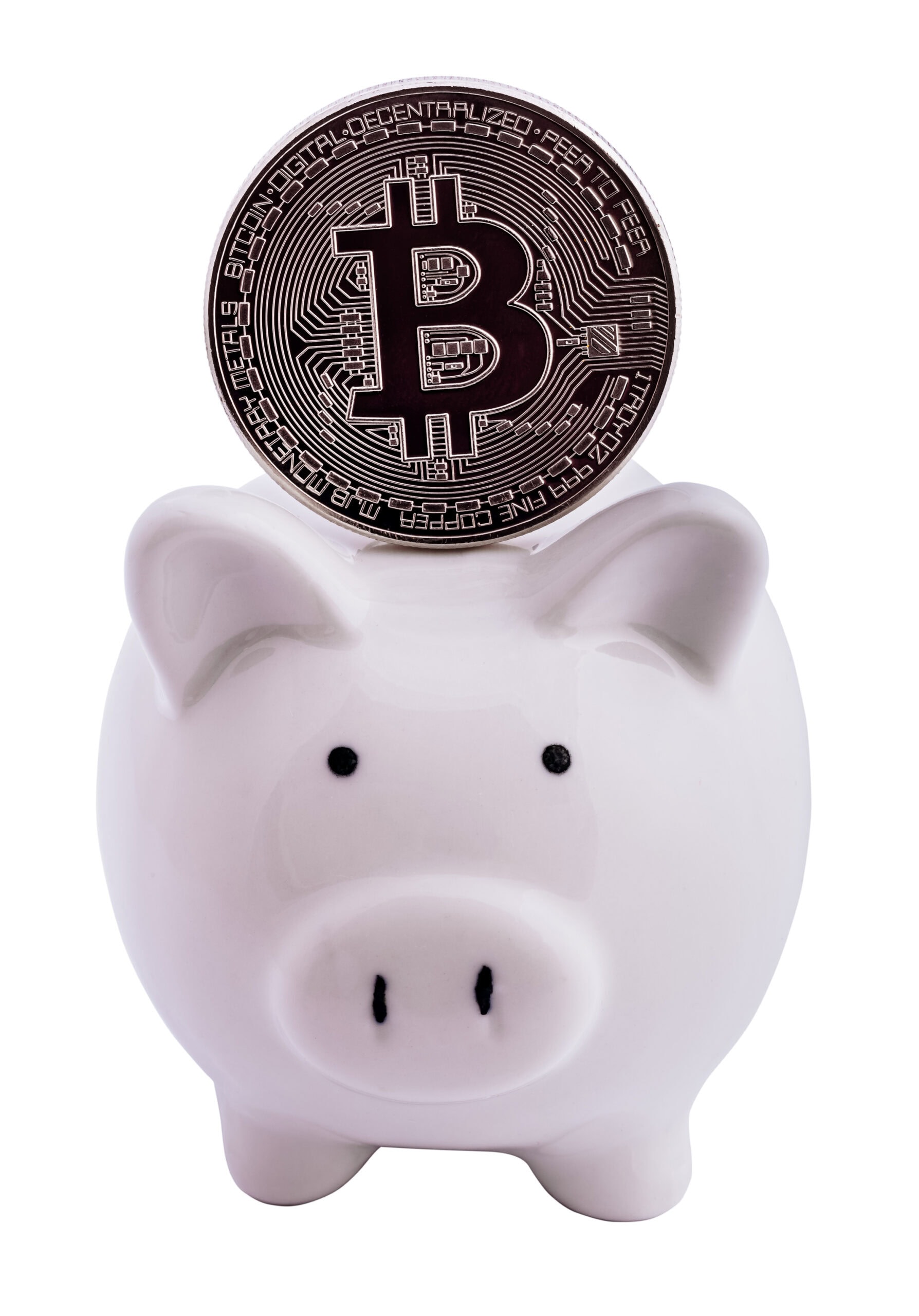 A silver Bitcoin coin is placed in the slot of a white ceramic piggy bank, symbolizing saving or investing in cryptocurrency. The background is plain and white.