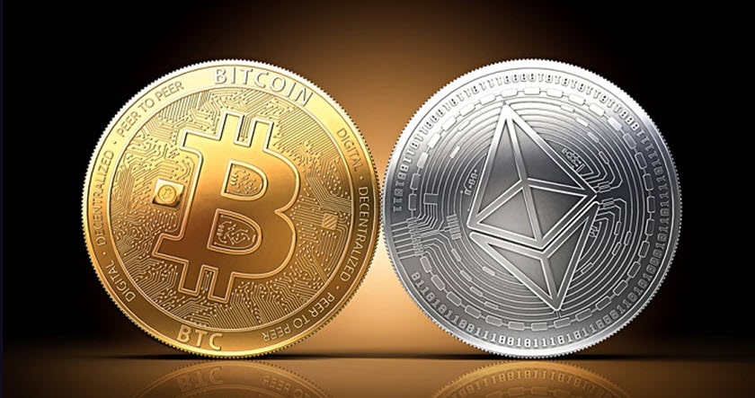 Two large coins displayed side by side: a gold Bitcoin on the left and a silver Ethereum coin on the right, both glowing against a dark background.