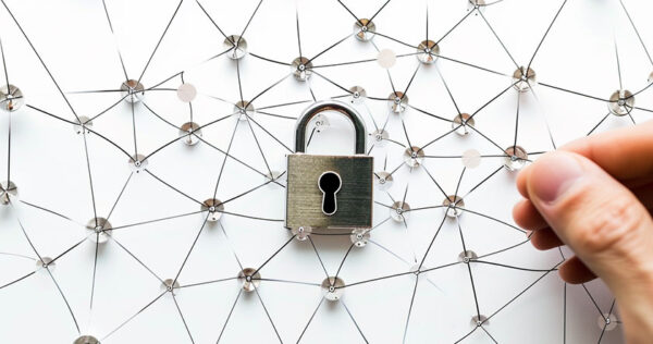 A hand adjusts a pin in a network of connected threads with a padlock at the center, symbolizing network security.
