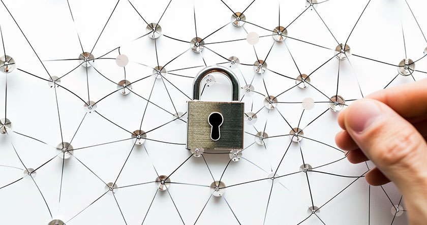 A hand adjusts a pin in a network of connected threads with a padlock at the center, symbolizing network security.