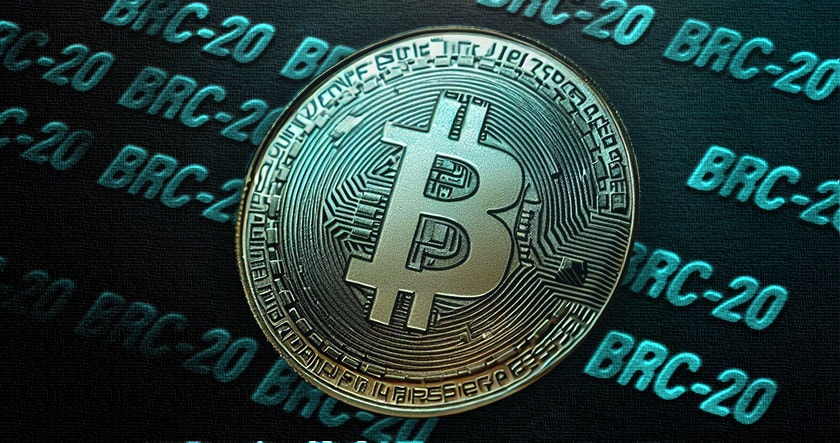 A metallic Bitcoin coin is shown on a surface with repeated "BRC-20" text in blue, referencing a token standard related to Bitcoin.