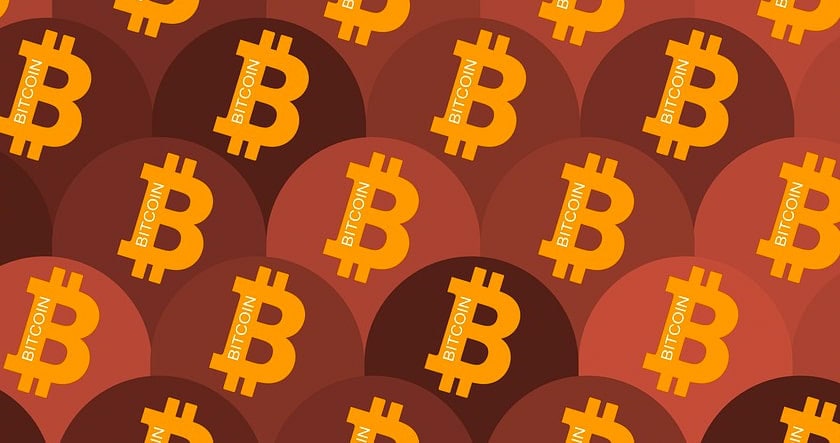Orange bitcoin symbols with the word "bitcoin" overlay a pattern of alternating dark red and brown circles.