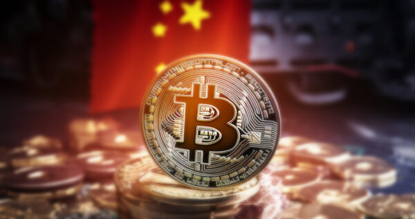 A Bitcoin coin is displayed in front of a blurred Chinese flag, with more coins scattered around the base.