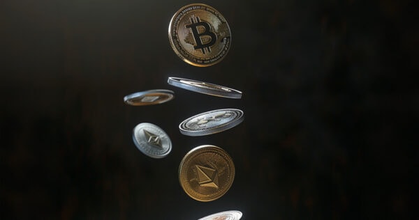 Gold and silver cryptocurrency coins, including Bitcoin and Ethereum, are suspended in mid-air against a dark background.