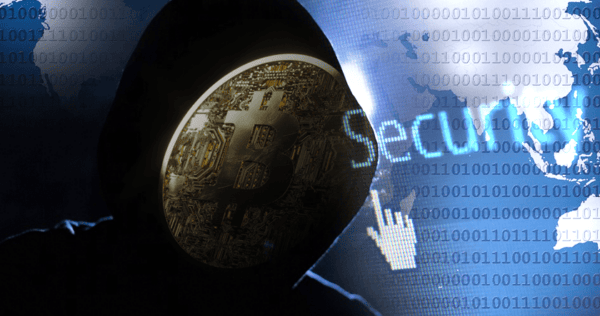 A person in a dark hoodie with a Bitcoin symbol over their face stands in front of digital security graphics and binary code.