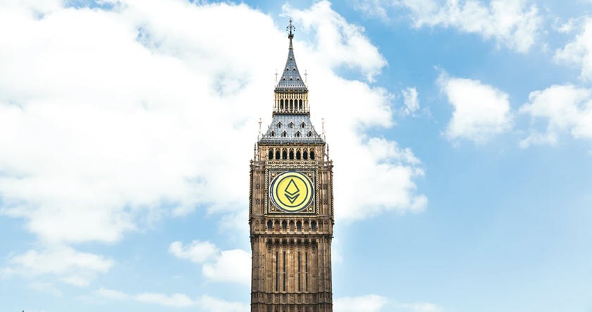 Big Ben clock tower with a stylized yellow and black emblem on its clock face, under a partly cloudy sky.