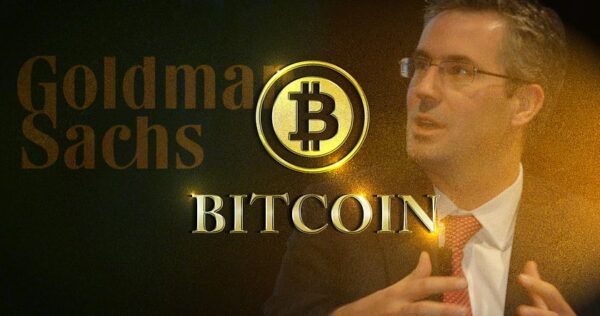 A man in a suit gestures while a glowing Bitcoin symbol and the words 