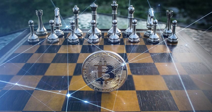A Bitcoin coin stands on a chessboard in front of silver chess pieces, with digital network lines overlaid on the image.