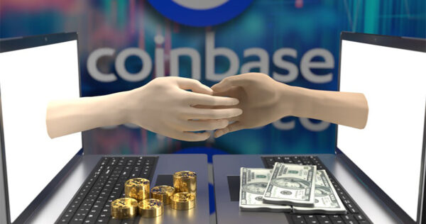 Two hands reach out from laptop screens exchanging cryptocurrency tokens and cash, with the Coinbase logo visible in the background.