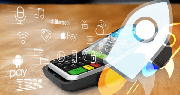 A smartphone with payment and technology icons, including Apple Pay, Android Pay, and Bluetooth, is placed on a card reader with a rocket graphic and IBM logo overlay.