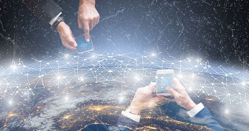 Two people use smartphones above an illustrated network of connected nodes, with a view of Earth and glowing city lights in the background.