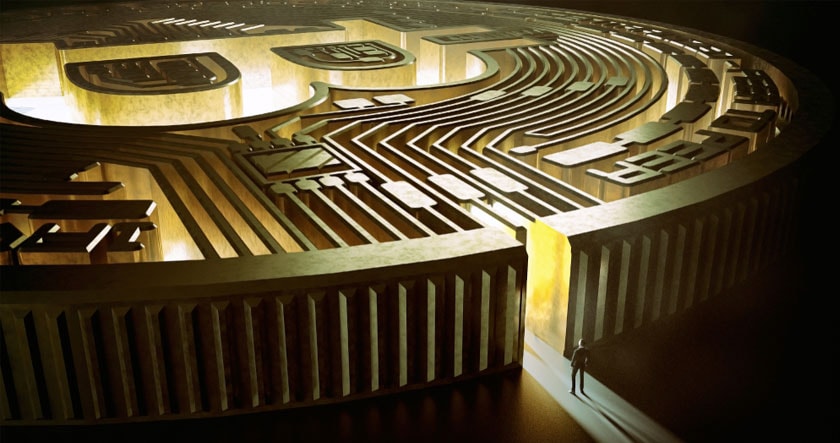 A person stands at the entrance of a large, golden maze resembling a Bitcoin symbol, illuminated by a beam of light.