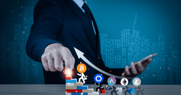 A person in a suit points at ascending blocks with cryptocurrency logos, representing growth, while holding a tablet; a white arrow shows upward progress.