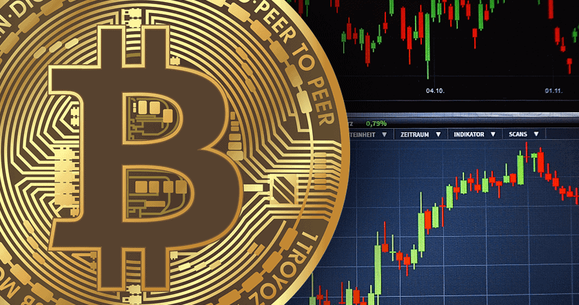A close-up of a Bitcoin symbol overlaid on a background showing candlestick charts and trading data on a computer screen.