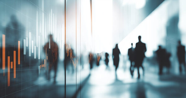 Blurry silhouettes of people walk through a modern glass building; a digital graph with bar and line data overlays the left side of the image.