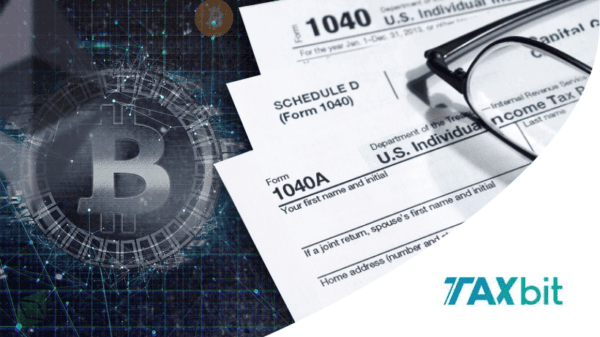 A digital Bitcoin symbol overlays tax forms, glasses, and the TaxBit logo, representing cryptocurrency and tax filing.