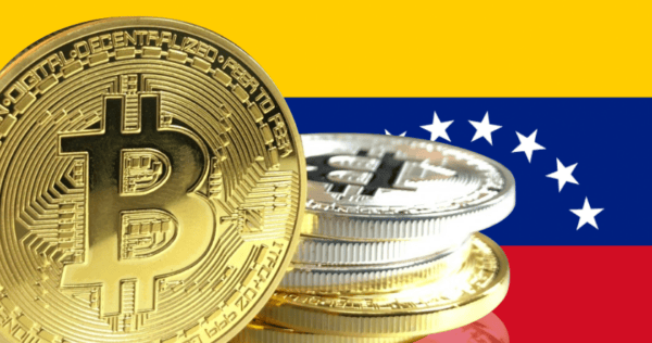 Stacks of Bitcoin coins are displayed in front of the Venezuelan flag.