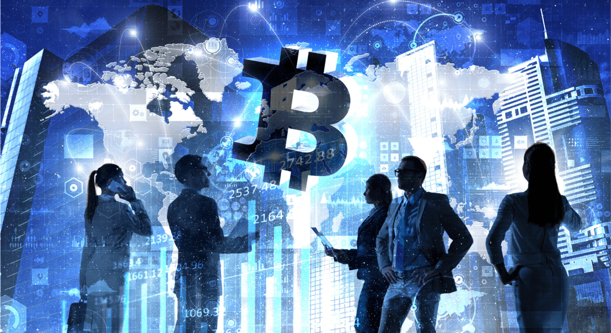Silhouetted businesspeople stand in front of digital screens and graphs with a large Bitcoin symbol and city buildings in the background.