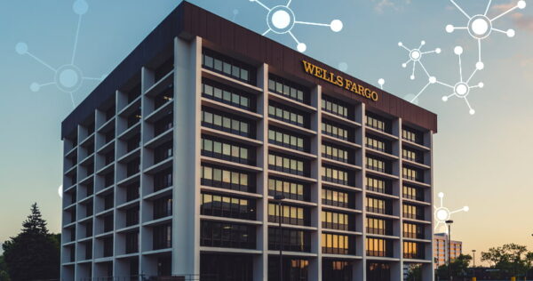 A Wells Fargo office building with large windows, seen at sunset, with digital network graphic overlays in the sky above.