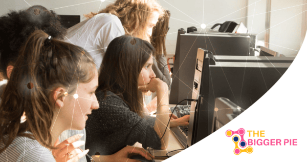 Several women sit at computers, focusing on their screens in a bright office setting. The Bigger Pie logo is visible in the bottom right corner.